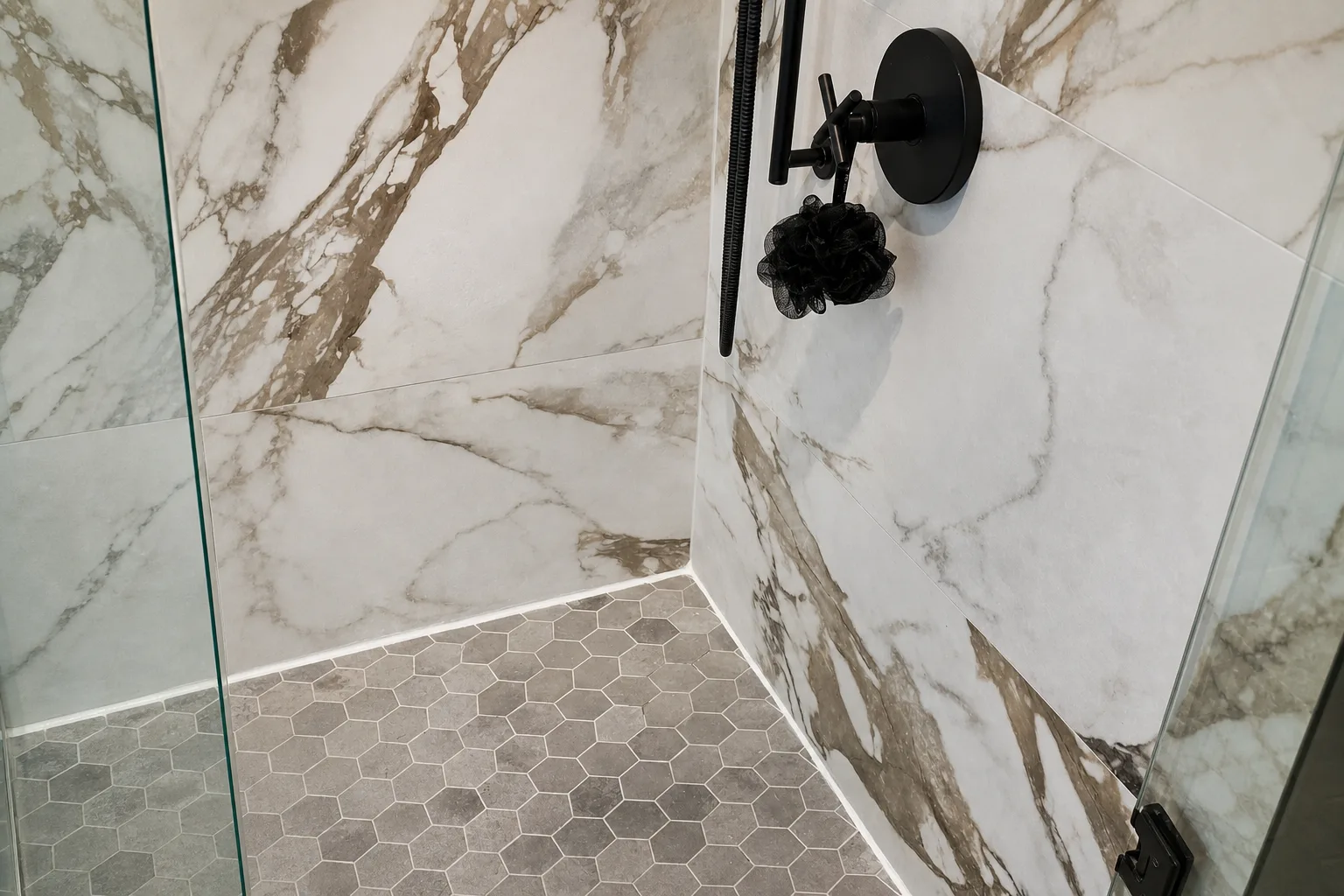 Detail: matte black shower fixtures on marble