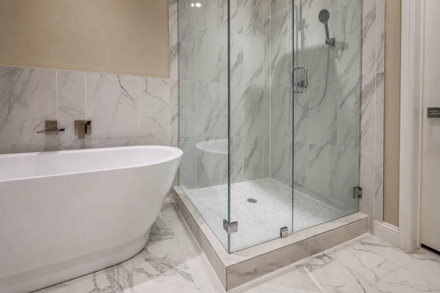 Curbless glass shower, marble tile surround