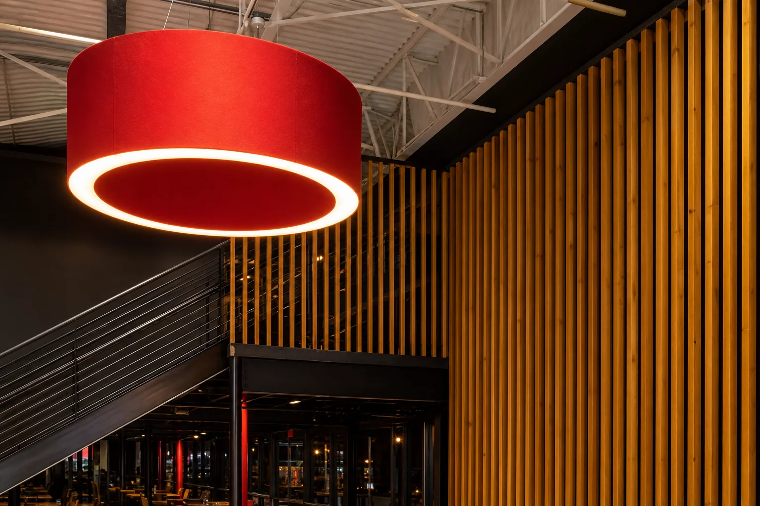 Statement pendant lighting against a custom slat wall