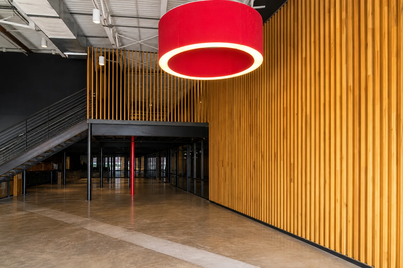Red pendant lighting against a custom slat wall