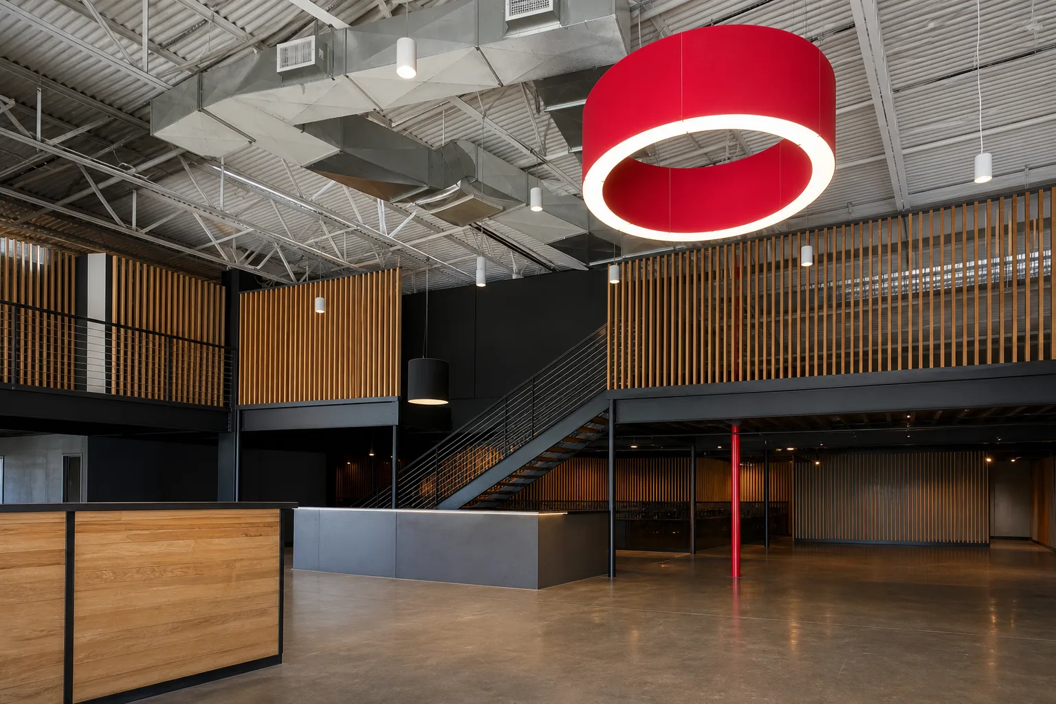 Statement drum pendant over a mezzanine lounge