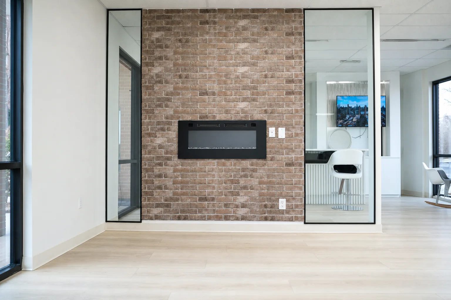 Custom fireplace wall framed by full-length mirrors
