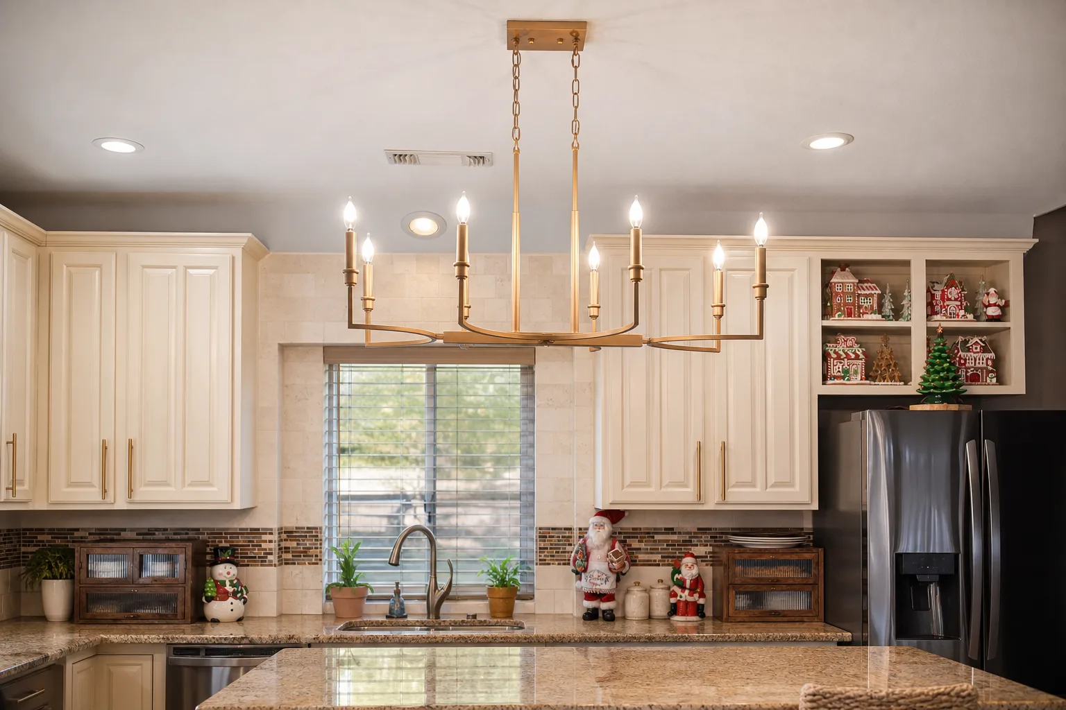 Brass linear chandelier over a kitchen island