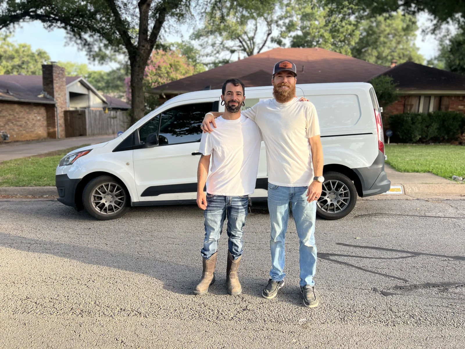 Bryan and Jayson Yerg standing together in front of the Yerg Remodeling work van